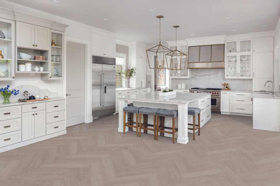 grey herringbone luxury vinyl in all white modern kitchen